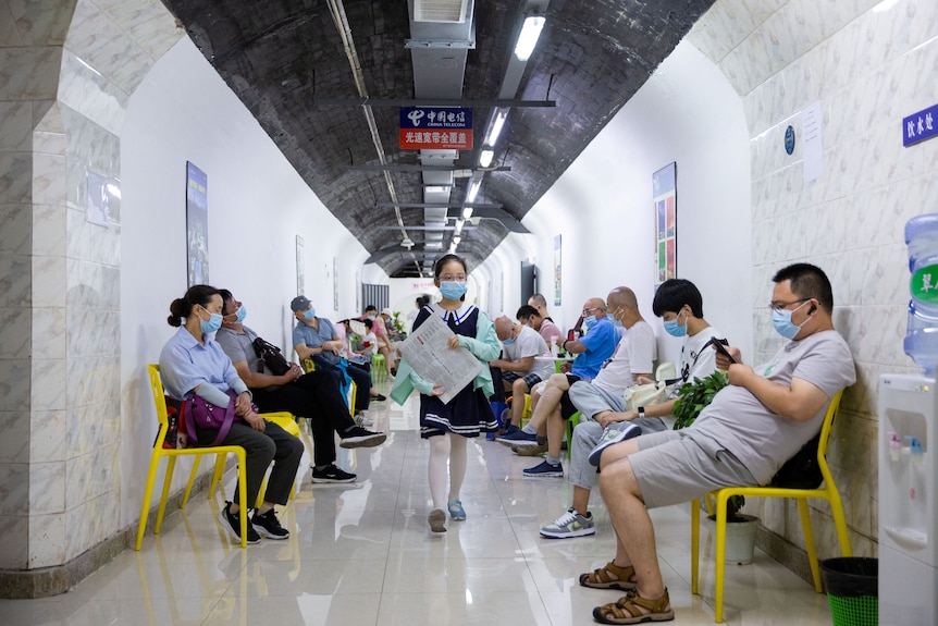 Locals in China sit in an air raid shelter