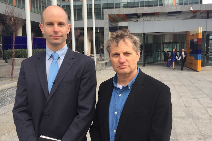 Lawyer David Barnden (left) and shareholder Guy Abrahams outside the Federal Court after launching legal action.