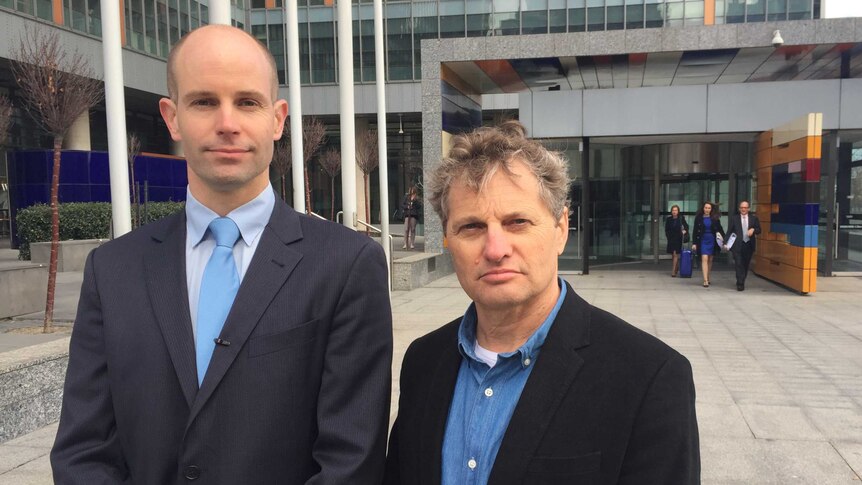 Lawyer David Barnden (left) and shareholder Guy Abrahams outside the Federal Court after launching legal action.