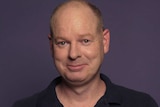 Tom Gleeson smiles at the camera in a still from an ABC Everyday video.