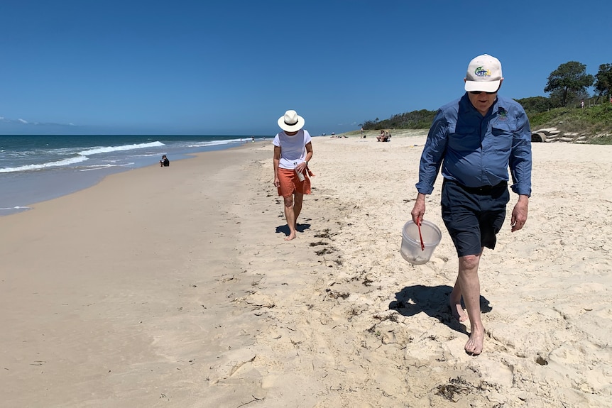 Local Bribie Island residents walked the beach with buckets picking up the small pieces of plastic.
