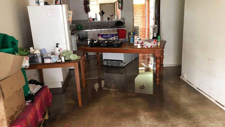 Muddy water on floor of damaged kitchen of Donald Mosby's flood-ravaged home in Mundingburra.