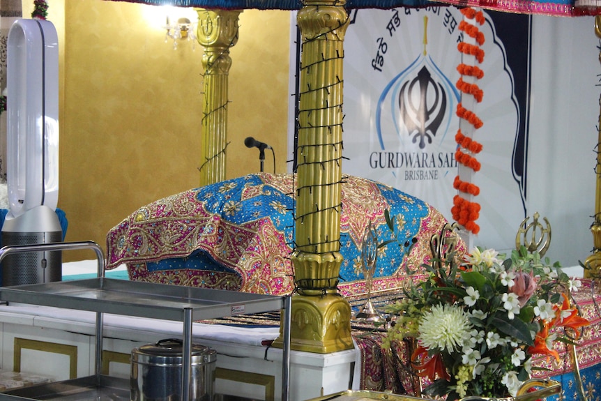 Ornate cushion at the Sikh temple alter, a microphone is ready for the priest.