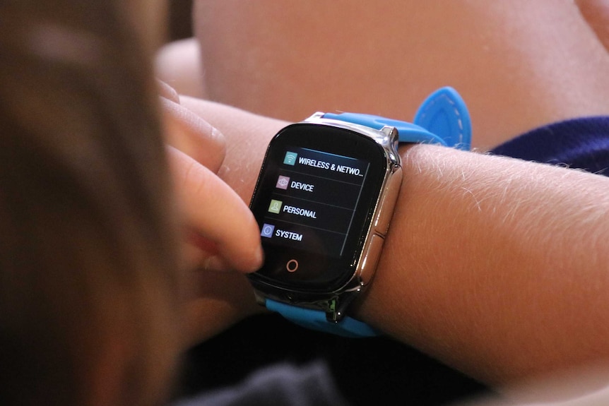 Close up of a smart watch, as worn by a seven-year-old boy.