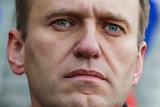 Russian opposition activist Alexei Navalny in front of a Russian flag