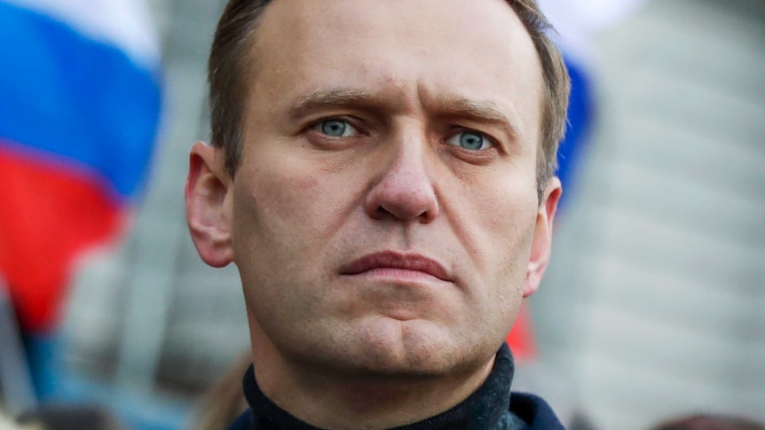 Russian opposition activist Alexei Navalny in front of a Russian flag