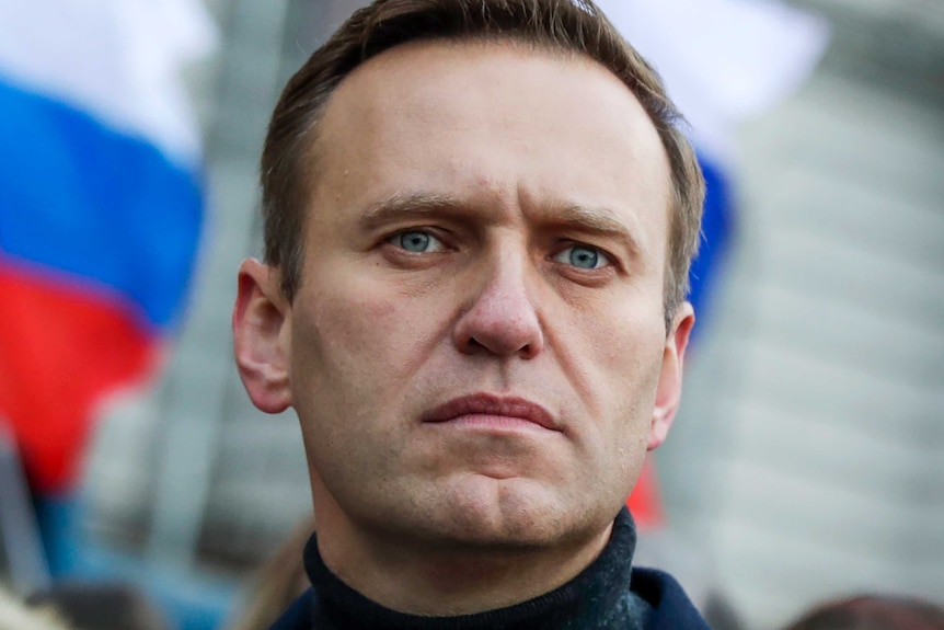 Russian opposition activist Alexei Navalny in front of a Russian flag