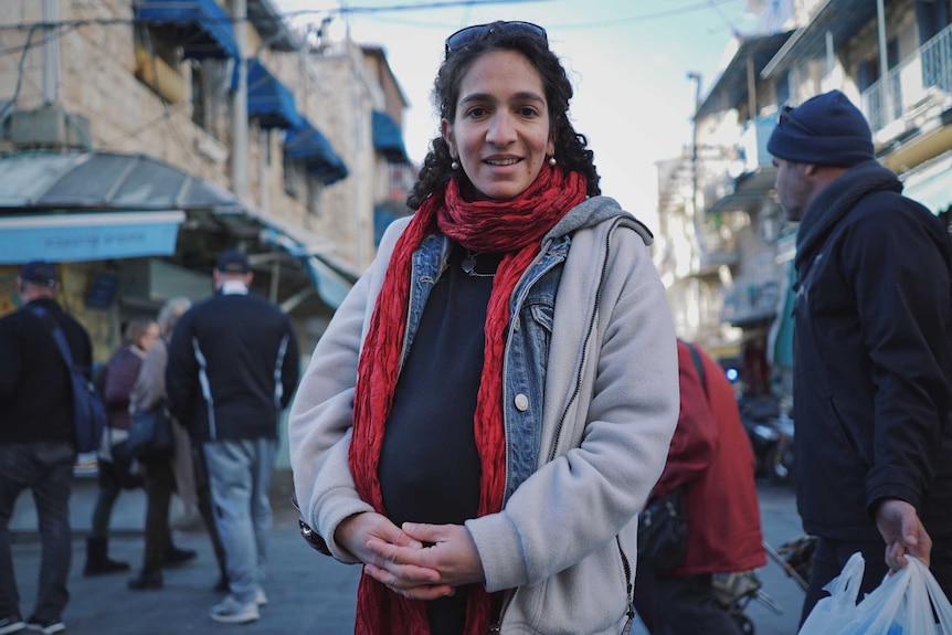 Elior Liss stands in front of some shops in Jerusalem.