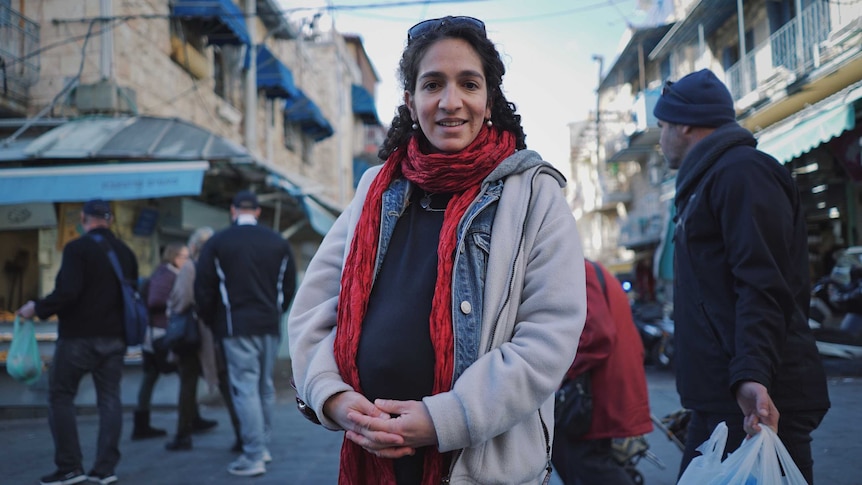 Elior Liss stands in front of some shops in Jerusalem.