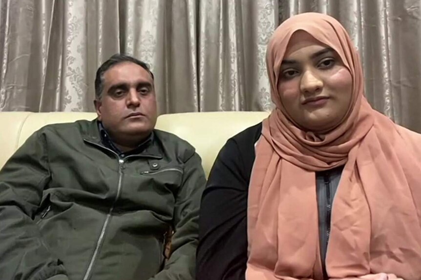 Tourqeer Balouch (left) sitting on a sofa with his daughter Noor Ul Ain (right)