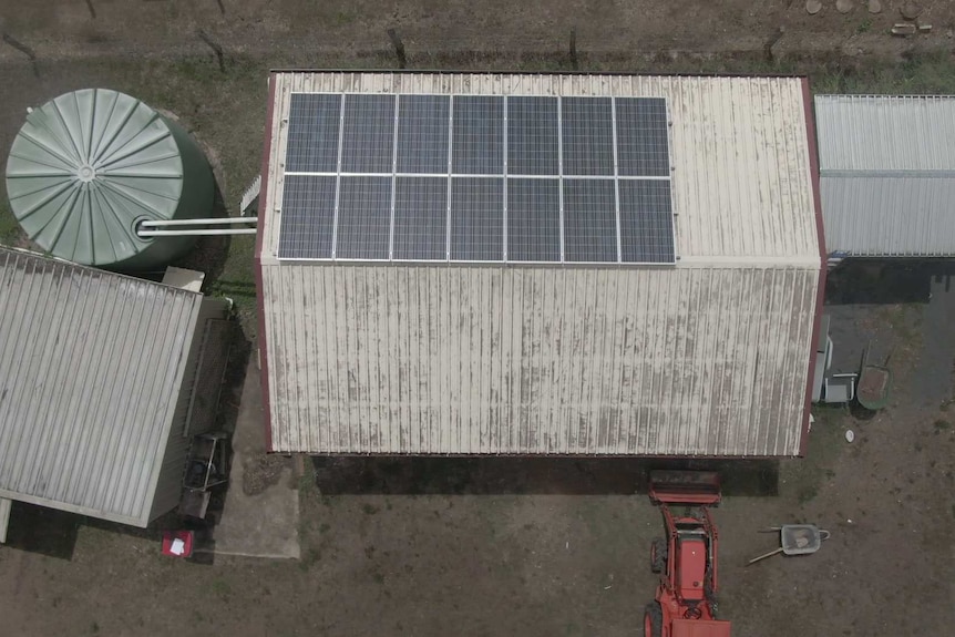 Solar panels sit on top of a roof.