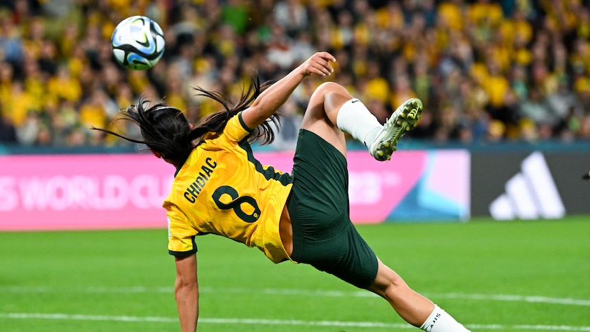 Alex Chidiac in a mid-air dive to headbutt the soccer ball