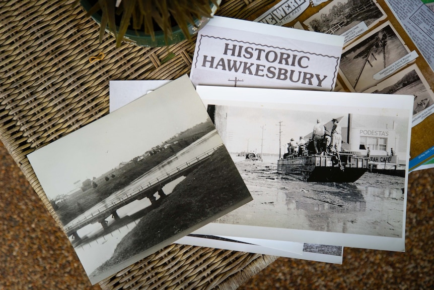 Black and white photographs and news clippings on a coffee table.
