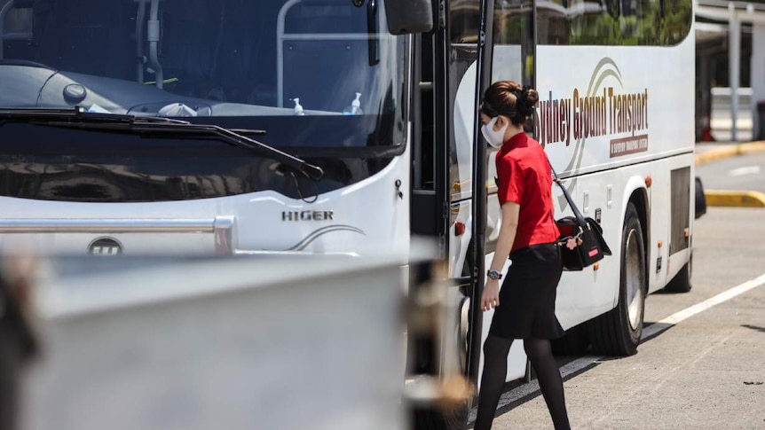 A woman gets on a bus