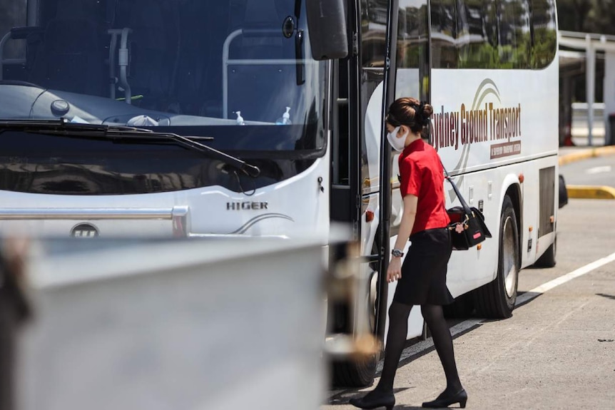 A woman gets on a bus