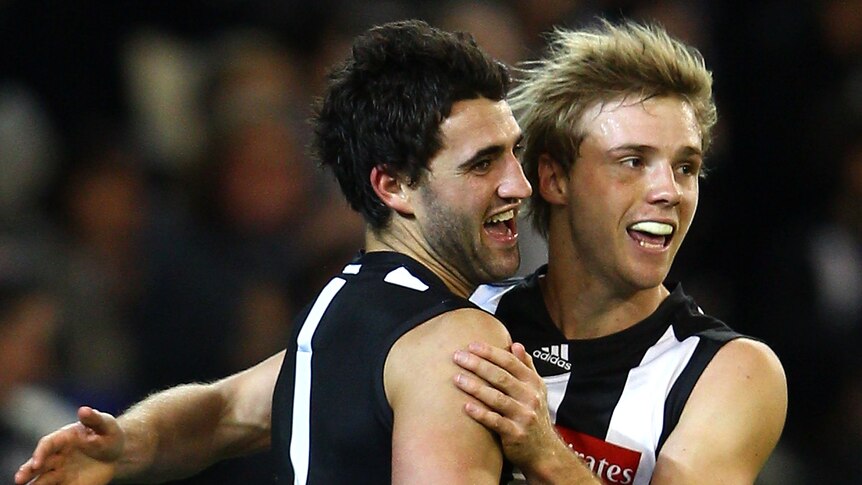 The Magpies' Alex Fasolo (L) celebrates a goal with Ben Sinclair against Geelong.