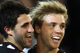 The Magpies' Alex Fasolo (L) celebrates a goal with Ben Sinclair against Geelong.