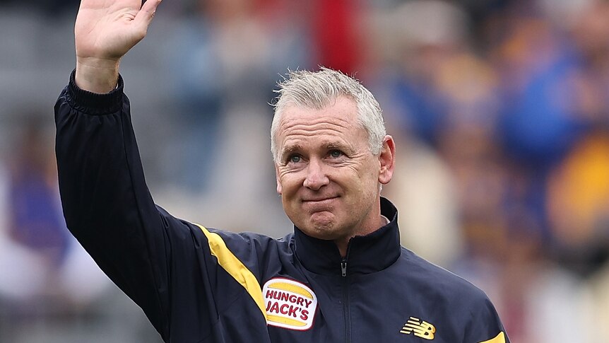 Adam Simpson waves to Eagles fans in the crowd before the game