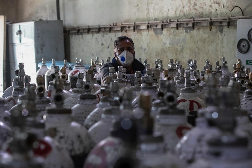 A hospital staff checks oxygen cylinders inside a hospital in Srinagar, Indian controlled Kashmir.