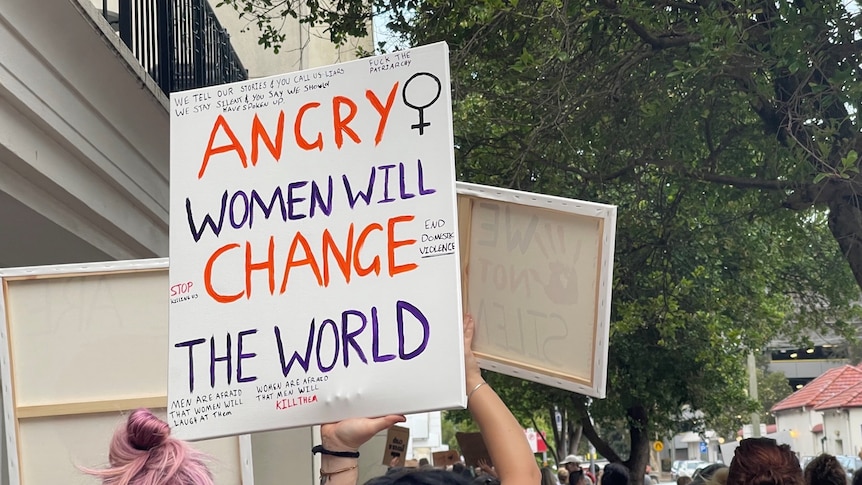 A close up of a sign that reads "Angry Women Will Change The World"