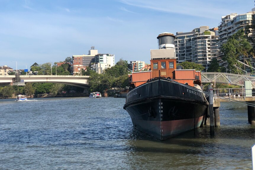 Old boat on inner city river dock