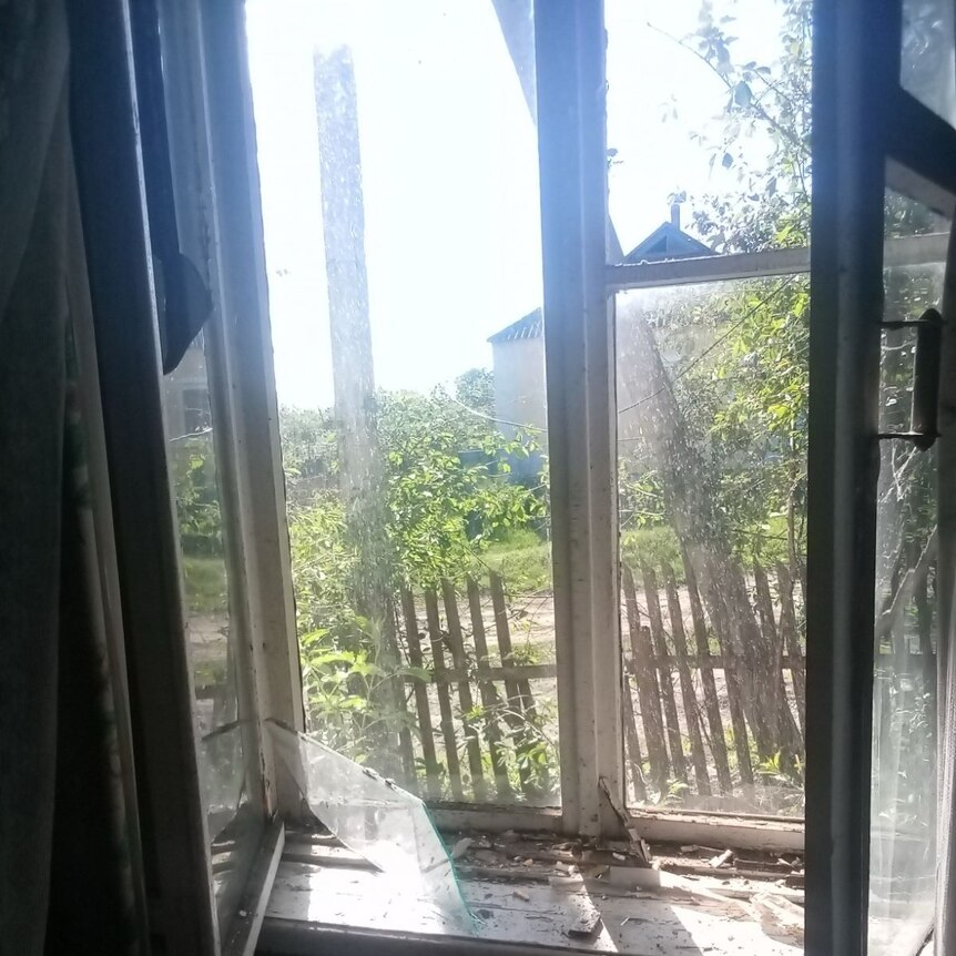 A smashed window, seen from the inside of a home.