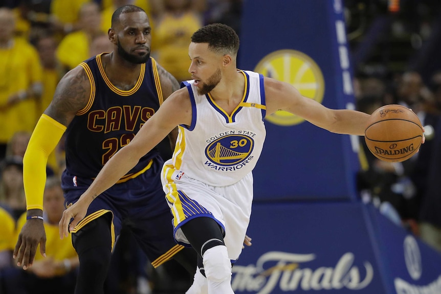 Steph Curry is guarded by LeBron James during the second half of Game 1.