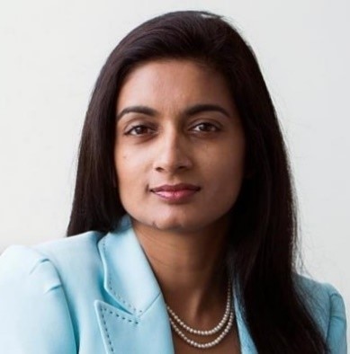 A lady with brown hair wearing a blue top