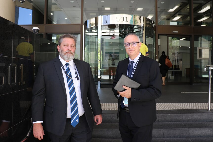 Detectives Gregory Hart and Leo Ricciardi stand outside a Perth court.