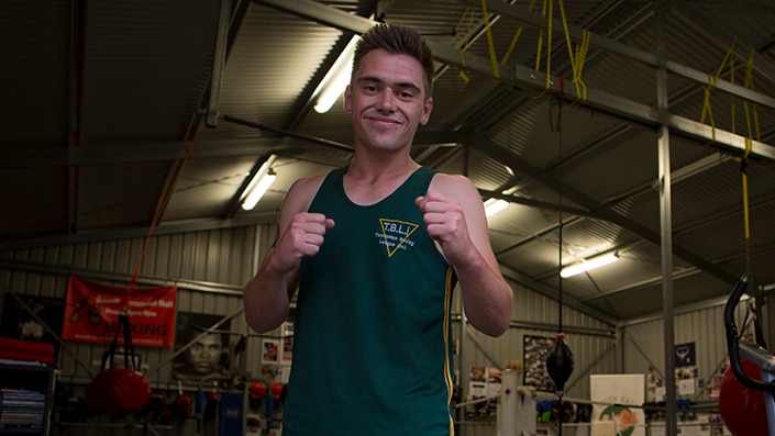 Local Dunalley boxer Jaidyn Panton faces the camera with a pose as he stands tall with no gloves on in the gym.