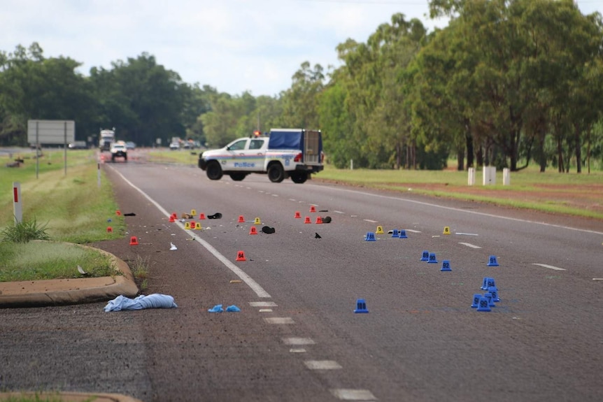 Markers are scene on the Stuart Highway outside Darwin, as police piece together the circumstances of a fatal collision.