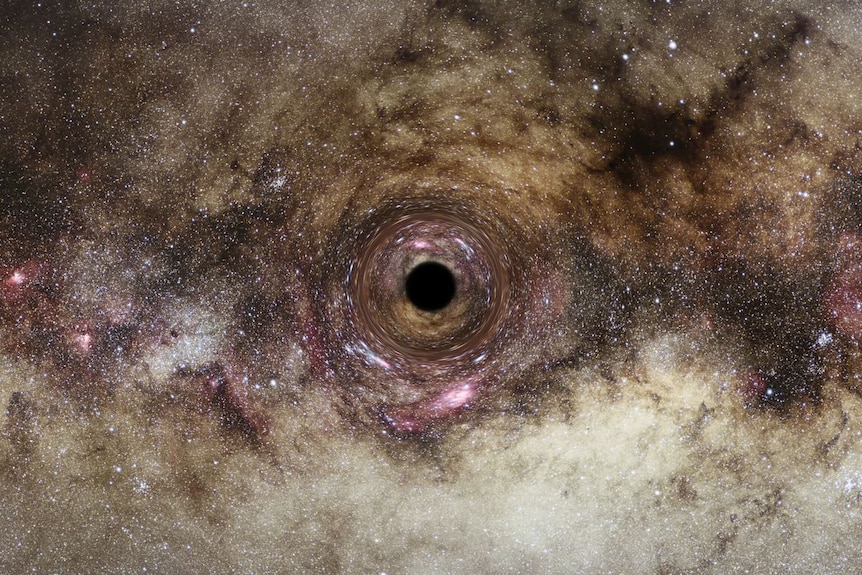 A grey and pink-tinged starfield has a dark black hole at its centre, around which the light from the stars seems to bend.