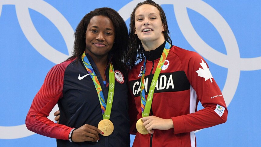 Simone Manuel and Penny Oleksiak claim their shared gold medals