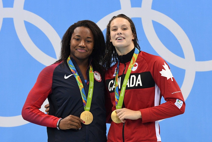 Simone Manuel and Penny Oleksiak claim their shared gold medals