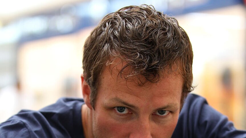 Surveying the field: Lucas Neill enjoys some down time at a Doha shopping centre.