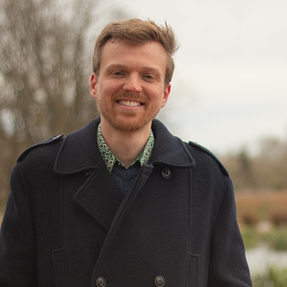 ABC presenter Matt Tribe standing in front of a wetland