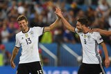 Winners are grinners ... Thomas Mueller (L) and Jonas Hector celebrate Germany's victory