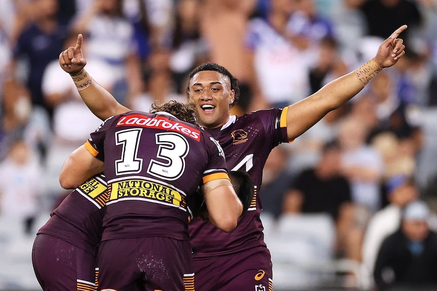 Rugby league players celebrate a victory 