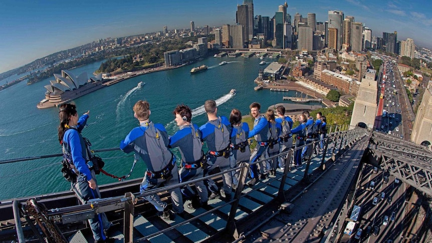 A group of people climbing the Sydney Harbour Bridge.