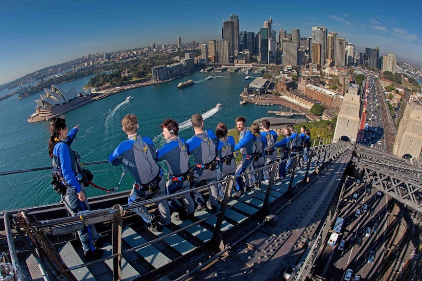 A group of people climbing the Sydney Harbour Bridge.