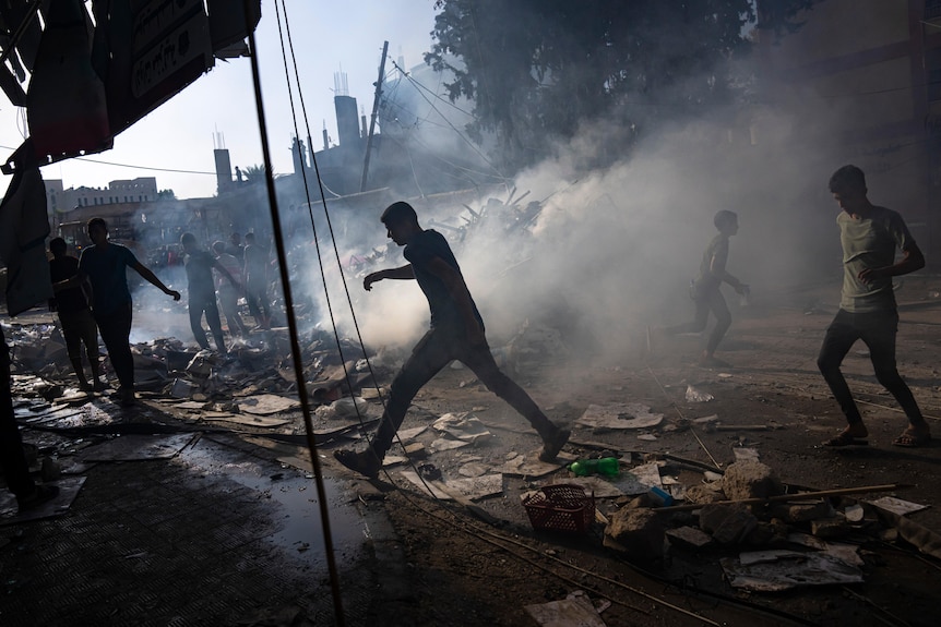Palestinians look for survivors following an Israeli airstrike in Khan Younis refugee camp.