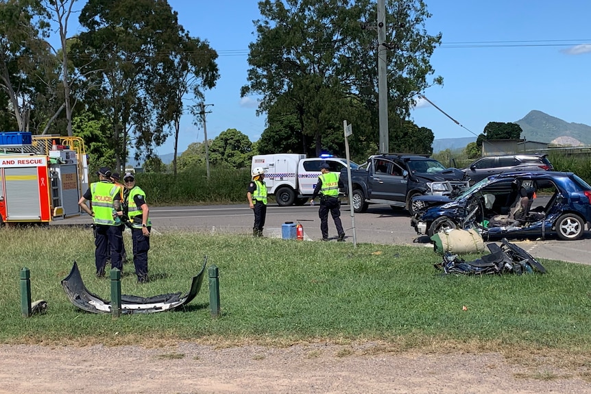 Officers standing at the scene of a bad road accident.