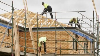 Builders constructing a house