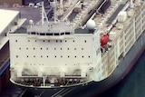 An aerial shot of a live export ship at port.