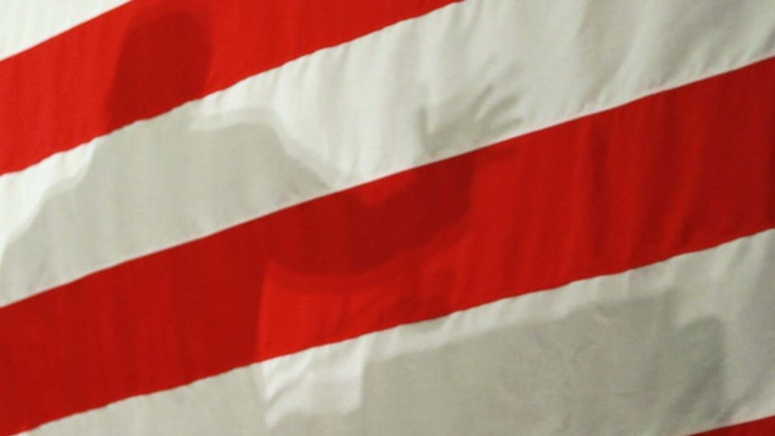 The shadow of a US electoral candidate is cast on an American flag in September 30, 2010. (Getty Images: Joe Raedle)