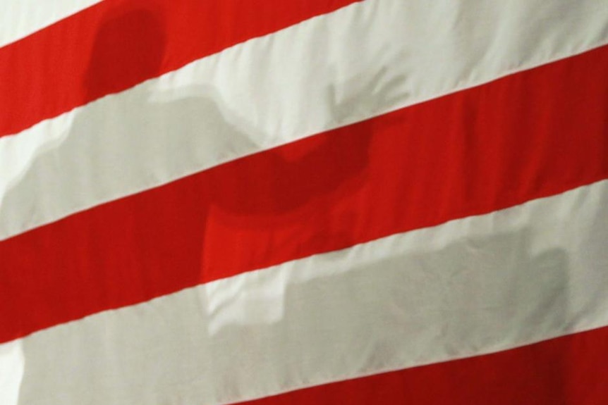 The shadow of a US electoral candidate is cast on an American flag in September 30, 2010. (Getty Images: Joe Raedle)