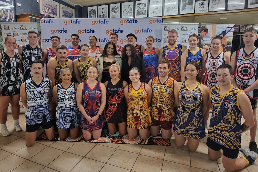 Alkina Edwards with GVL players wearing the jumpers and dresses she designed.