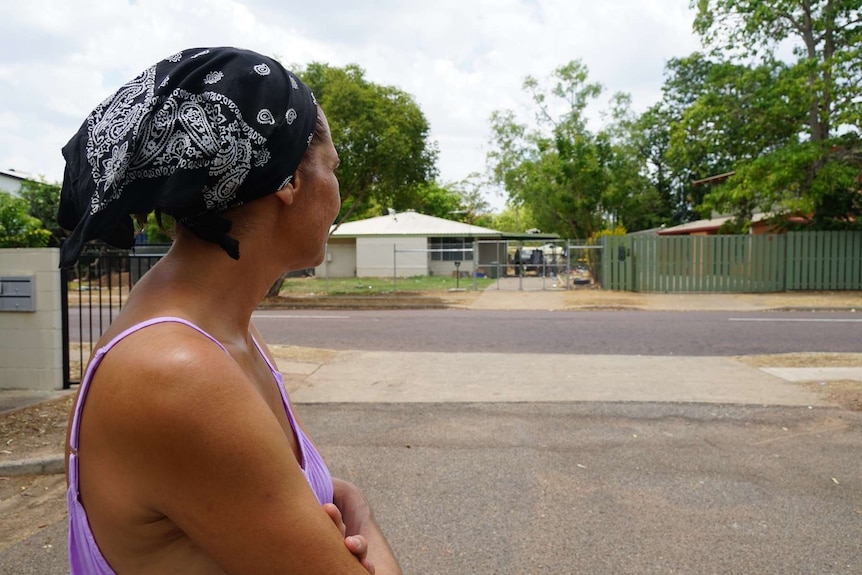 Eyewitness Sharlene Keegan looks across her street to a fence line and house where a brawl allegedly took place.