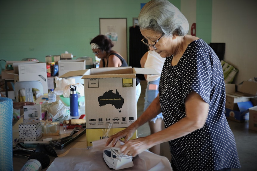 A lady packing an iron as a donation for Timor-Leste