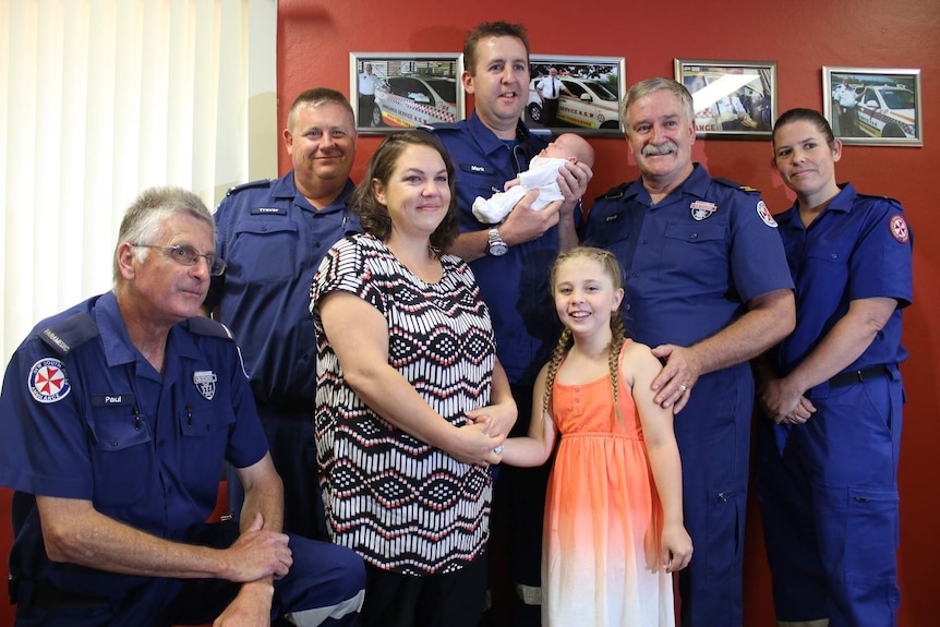 Madison Dunstan with her mother, brother and members of the NSW ambulance